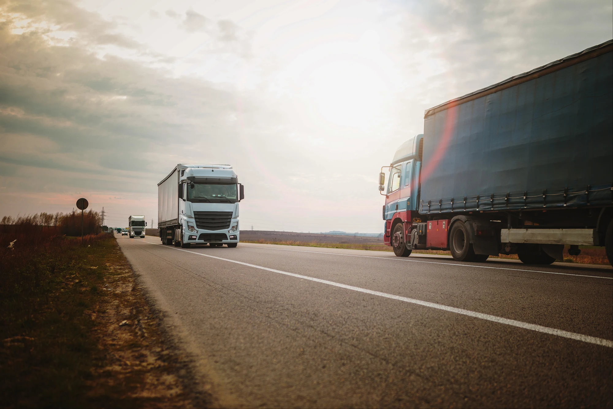 Freight trucks travelling along an open road