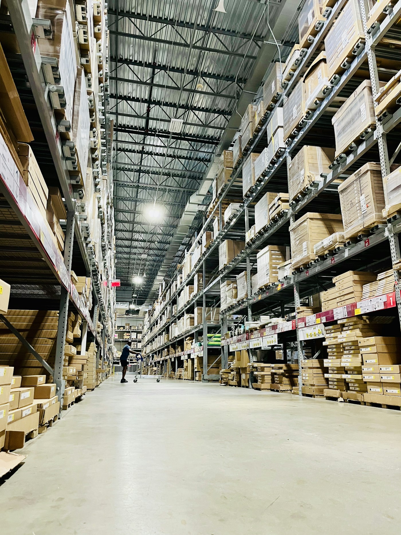 Orderly warehouse with neatly stacked stock and a clear aisle